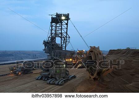 "Bucket-wheel excavator in an opencast pit, at the blue hour, Grevenbroich, North Rhine-Westphalia, Germany, Europe" View Large Photo Image Stock Photo - "Bucket-wheel excavator in an opencast pit, at the blue hour, Grevenbroich, North Rhine-Westphalia, Germany, Europe". Fotosearch