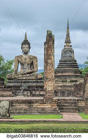 Stock Photograph - "Buddha statue at the ruins of Wat Phra Si Rattana Mahathat temple complex, Sukhothai Historical Park, UNESCO World Heritage Site, Sukhothai, Thailand, Asia". Fotosearch