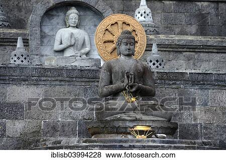 Stock Photo - "Buddha statue on an altar outside of the Buddhist Brahma Vihara Monastery, Banjar, North Bali, Bali, Indonesia, Asia". Fotosearch