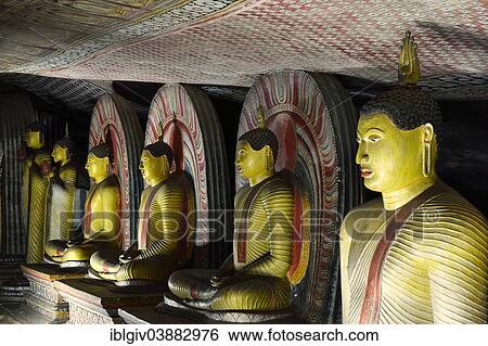 Stock Photograph - "Buddha statues and murals in one of the cave temples of the Golden Temple, UNESCO World Heritage Site, Dambulla, Central Province, Sri Lanka, Asia". Fotosearch