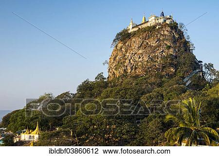 Stock Image - "Buddhist monastery, gilded Tuyin Taung Pagoda on the Taung Kalat volcanic cone, Mount Popa, Mandalay Region, Myanmar, Asia". Fotosearch