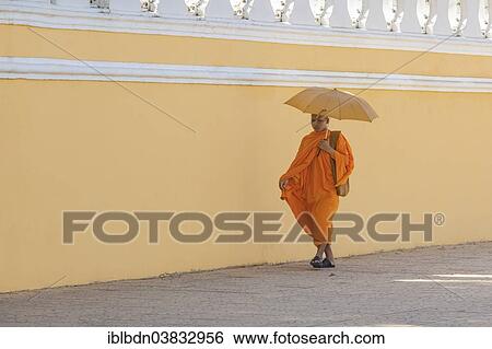 Stock Photograph - "Buddhist monk walking along the walls of the Royal Palace, Phnom Penh, Cambodia, Asia". Fotosearch
