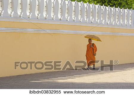 Stock Photography - "Buddhist monk walking along the walls of the Royal Palace, Phnom Penh, Cambodia, Asia". Fotosearch