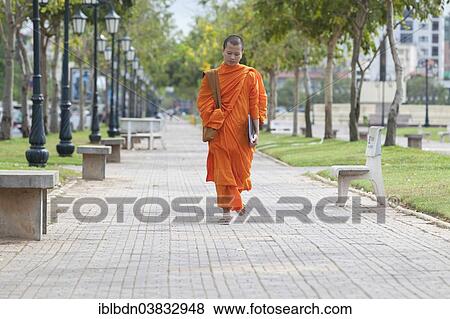 "Buddhist monk walking in central Phnom Penh, Cambodia, Asia" View Large Photo Image Stock Photo - "Buddhist monk walking in central Phnom Penh, Cambodia, Asia". Fotosearch