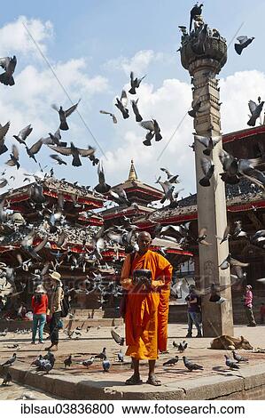 "Buddhist monk with a begging bowl standing in front of Hindu temples, many pigeons flying up, pagoda, square outside the Hanuman Dhoka Royal Palace, Durbar Square, Kathmandu, Kathmandu District, Bagmati Zone, Nepal, Asia" View Large Photo Image Stock Image - "Buddhist monk with a begging bowl standing in front of Hindu temples, many pigeons flying up, pagoda, square outside the Hanuman Dhoka Royal Palace, Durbar Square, Kathmandu, Kathmandu District, Bagmati Zone, Nepal, Asia". Fotosearch