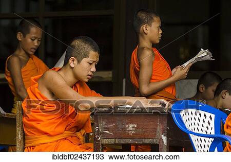 Stock Image - "Buddhist monks being taught in a monastery school, Wat Chong Kham temple complex, Ngao area, Lampang Province, Thailand, Asia". Fotosearch