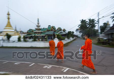 Stock Image - "Buddhist monks collecting alms, Temples of Wat Jong Kham and Chong Kham or Wat Jong Klang and Chong Klang, Mae Hong Son, Northern Thailand, Thailand, Asia". Fotosearch
