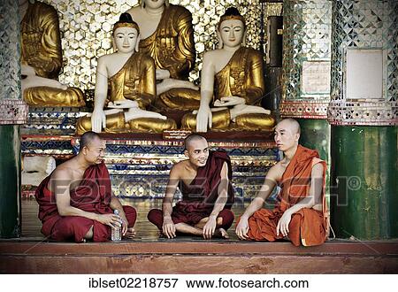 "Buddhist monks sitting in front of Buddha statues in the Shwedagon Pagoda, Yangon, Burma also known as Myanmar, Southeast Asia, Asia" View Large Photo Image Stock Photo - "Buddhist monks sitting in front of Buddha statues in the Shwedagon Pagoda, Yangon, Burma also known as Myanmar, Southeast Asia, Asia". Fotosearch