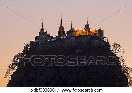 "Buddhist nonastery, Tuyin Taung Pagoda on the volcanic cone of Taung Kalat, at sunset, Mount Popa, Mandalay Region, Myanmar, Asia" View Large Photo Image Stock Photo - "Buddhist nonastery, Tuyin Taung Pagoda on the volcanic cone of Taung Kalat, at sunset, Mount Popa, Mandalay Region, Myanmar, Asia". Fotosearch