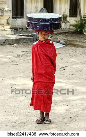 Buddhist novice carrying a box on his head, Myanmar, Burma, Southeast Asia, Asia View Large Photo Image Stock Photo - Buddhist novice carrying a box on his head, Myanmar, Burma, Southeast Asia, Asia. Fotosearch