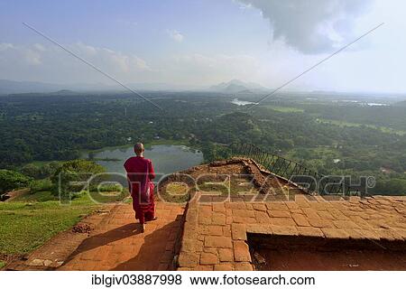 "Buddhist nun enjoying the view from the ruins of the fortress on the Lion Rock, Sigiriya, UNESCO World Heritage Site, Sigiriya, Central Province, Sri Lanka, Asia" View Large Photo Image Stock Photo - "Buddhist nun enjoying the view from the ruins of the fortress on the Lion Rock, Sigiriya, UNESCO World Heritage Site, Sigiriya, Central Province, Sri Lanka, Asia". Fotosearch