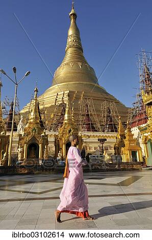 Picture - "Buddhist nun in front of Shwedagon Pagoda, Yangon, Yangon Region, Myanmar, Burma, Asia". Fotosearch
