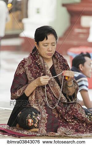 "Buddhist woman in morning prayer at the Shwedagon Pagoda, with prayer beads, Yangon, Myanmar, Asia" View Large Photo Image Stock Photograph - "Buddhist woman in morning prayer at the Shwedagon Pagoda, with prayer beads, Yangon, Myanmar, Asia". Fotosearch
