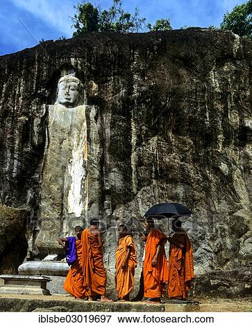 "Buduruvagala, rock of Buddhist sculptures, Monks standing in front of the Deepangkara Buddha statue, Buduruvagala, Budurula, Wellawaya, Monaragala Distrikt, Sri Lanka, Asia" View Large Photo Image Stock Photo - "Buduruvagala, rock of Buddhist sculptures, Monks standing in front of the Deepangkara Buddha statue, Buduruvagala, Budurula, Wellawaya, Monaragala Distrikt, Sri Lanka, Asia". Fotosearch