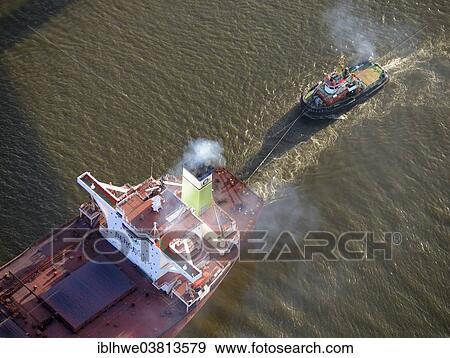 "Bugsier 9 tug boat towing the Bergebulk Arctic from the harbor, Hamburg, Germany, Europe" View Large Photo Image Stock Photo - "Bugsier 9 tug boat towing the Bergebulk Arctic from the harbor, Hamburg, Germany, Europe". Fotosearch