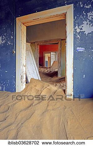 Stock Image - "Building taken over by sand from the desert, former diamond mining town, now a ghost town, Kolmanskop, Luderitz, Karas Region, Namibia, Africa". Fotosearch