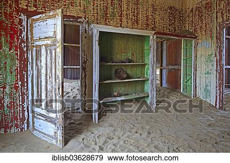 Stock Photo - "Building taken over by sand from the desert, former diamond mining town, now a ghost town, Kolmanskop, Luderitz, Karas Region, Namibia, Africa". Fotosearch