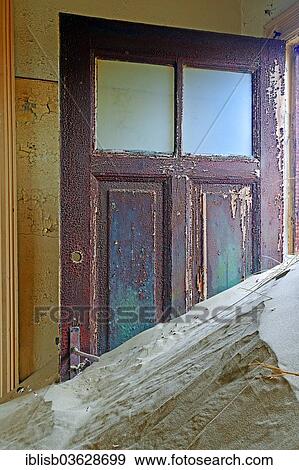 Stock Photo - "Building taken over by sand from the desert, former diamond mining town, now a ghost town, Kolmanskop, Luderitz, Karas Region, Namibia, Africa". Fotosearch