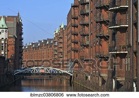 Stock Photograph - "Buildings and Poggenmuehlenbruecke bridge in the Speicherstadt historic warehouse district, Hamburg, Germany, Europe". Fotosearch