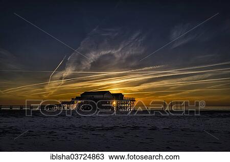 "Buildings on stilts on the beach against the setting sun, St. Peter-Ording, Eiderstedt, North Frisia, Schleswig-Holstein, Germany, Europe" View Large Photo Image Stock Image - "Buildings on stilts on the beach against the setting sun, St. Peter-Ording, Eiderstedt, North Frisia, Schleswig-Holstein, Germany, Europe". Fotosearch