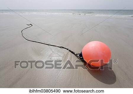 Stock Image - "Buoy lying on the beach, Schleswig-Holstein, Germany, Europe". Fotosearch