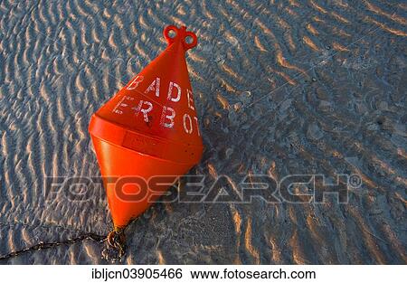 "Buoy marked """"Badeverbot"""", German for """"no swimming"""", lying on the beach in the evening, Sankt-Peter-Ording, North Frisia, Schleswig-Holstein, Germany, Europe" View Large Photo Image Stock Photograph - "Buoy marked """"Badeverbot"""", German for """"no swimming"""", lying on the beach in the evening, Sankt-Peter-Ording, North Frisia, Schleswig-Holstein, Germany, Europe". Fotosearch