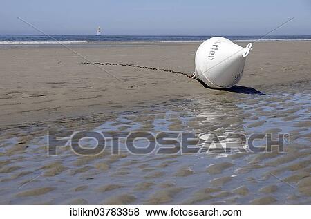 Stock Photo - "Buoy marked """"Surfen"""" lying on the beach, St. Peter-Ording, Schleswig-Holstein, Germany, Europe". Fotosearch
