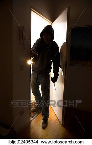 Burglar entering an apartment View Large Photo Image Picture - Burglar entering an apartment. Fotosearch