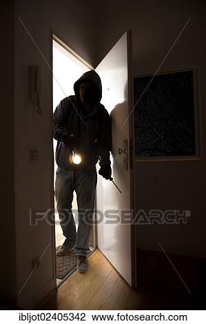 Burglar entering an apartment View Large Photo Image Stock Image - Burglar entering an apartment. Fotosearch