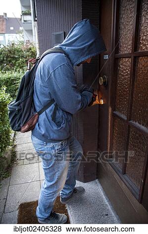 Burglar prying open a door in broad daylight View Large Photo Image Stock Photo - Burglar prying open a door in broad daylight. Fotosearch