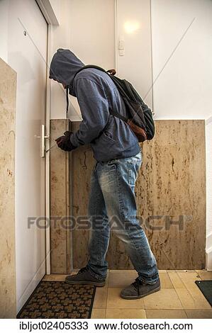 Burglar prying open an apartment door View Large Photo Image Stock Image - Burglar prying open an apartment door. Fotosearch