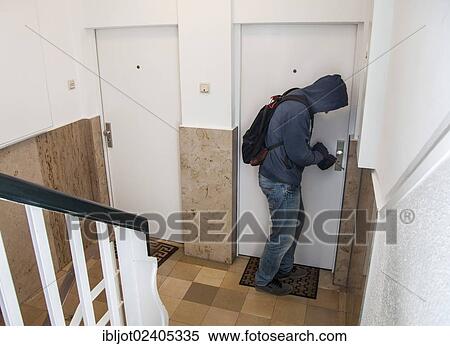 Burglar prying open an apartment door View Large Photo Image Stock Photography - Burglar prying open an apartment door. Fotosearch