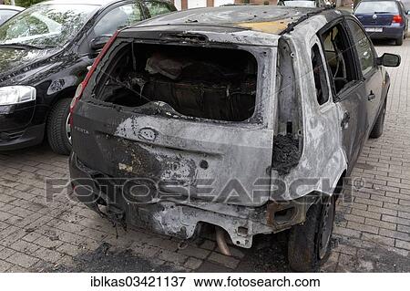 Stock Photo - "Burnt out Ford Fiesta in a car park, Dusseldorf, Rhineland, North Rhine-Westphalia, Germany, Europe". Fotosearch