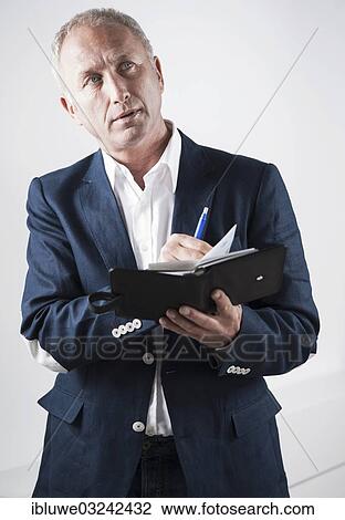 "Businessman holding an appointment calendar, Mannheim, Baden-Wurttemberg, Germany, Europe" View Large Photo Image Stock Image - "Businessman holding an appointment calendar, Mannheim, Baden-Wurttemberg, Germany, Europe". Fotosearch