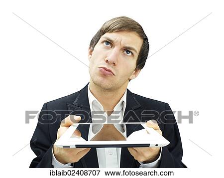 Stock Photo - "Businessman holding an iPad, pensive face". Fotosearch