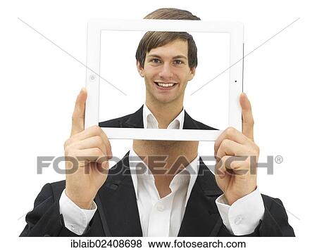 Stock Photo - Businessman holding an iPad with a self portrait in front of his face. Fotosearch