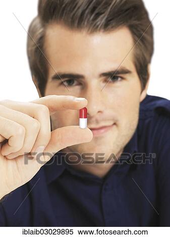Businessman holding capsule View Large Photo Image Stock Photography - Businessman holding capsule. Fotosearch