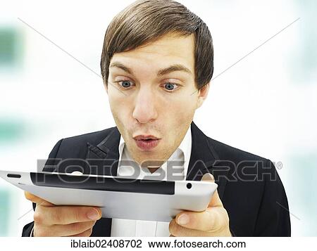 "Businessman looking at an iPad, focused, amazed, surprised, portrait" View Large Photo Image Stock Image - "Businessman looking at an iPad, focused, amazed, surprised, portrait". Fotosearch