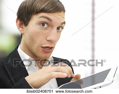 "Businessman working on an iPad, focused, stressed, portrait" View Large Photo Image Stock Image - "Businessman working on an iPad, focused, stressed, portrait". Fotosearch
