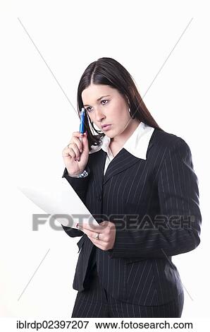 "Businesswoman holding a pen and a letter, pondering" View Large Photo Image Stock Photo - "Businesswoman holding a pen and a letter, pondering". Fotosearch