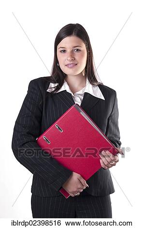 Stock Photograph - "Businesswoman holding a red folder, smiling". Fotosearch