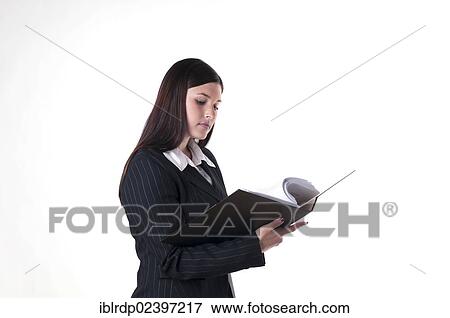 Businesswoman looking into a folder View Large Photo Image Stock Photo - Businesswoman looking into a folder. Fotosearch