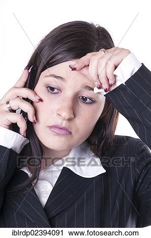 Stock Image - "Businesswoman on the phone, looking distraught". Fotosearch