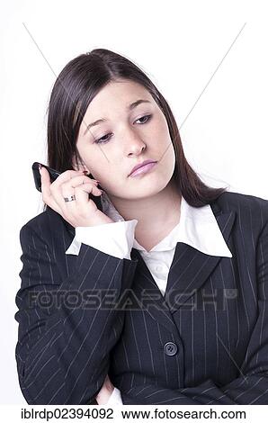 Stock Image - "Businesswoman on the phone, looking bored". Fotosearch