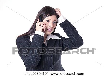 Stock Image - "Businesswoman on the phone, looking concerned, brooding". Fotosearch