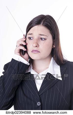 Stock Photo - "Businesswoman on the phone, looking sad". Fotosearch