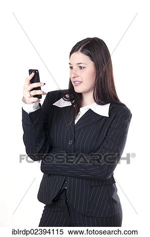 Stock Photography - "Businesswoman using a smartphone, looking pleased". Fotosearch