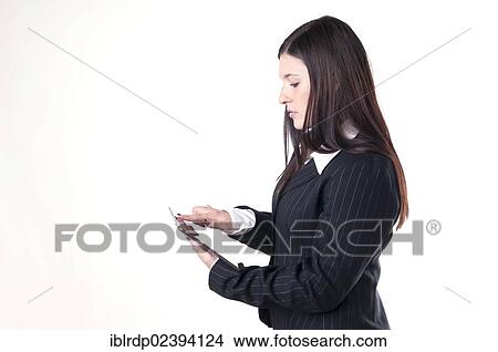 Businesswoman using a tablet PC View Large Photo Image Picture - Businesswoman using a tablet PC. Fotosearch