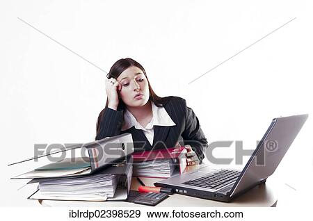 "Businesswoman with folders, a laptop and a calculator, looking exhausted and supporting her head" View Large Photo Image Stock Photo - "Businesswoman with folders, a laptop and a calculator, looking exhausted and supporting her head". Fotosearch
