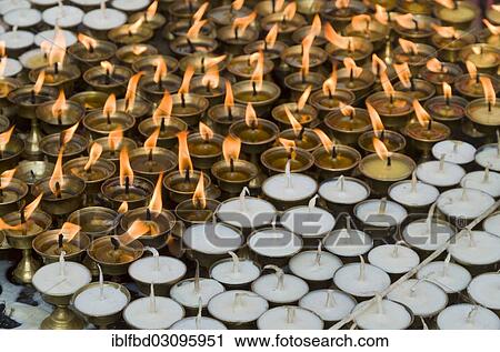 Stock Image - "Butterlamps, lighted and unlighted, as offerings at Boudnath Stupa, Kathmandu Valley, Kathmandu, Kathmandu District, Bagmati Zone, Nepal, Asia". Fotosearch